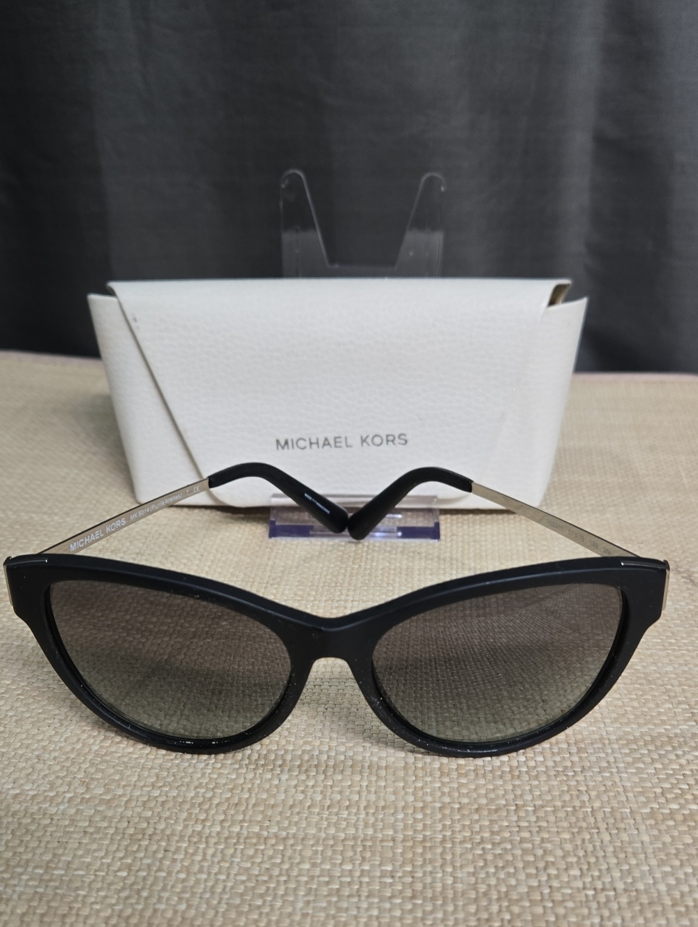 Michael Kors Black Cat-Eye Sunglasses with Gradient Lenses.